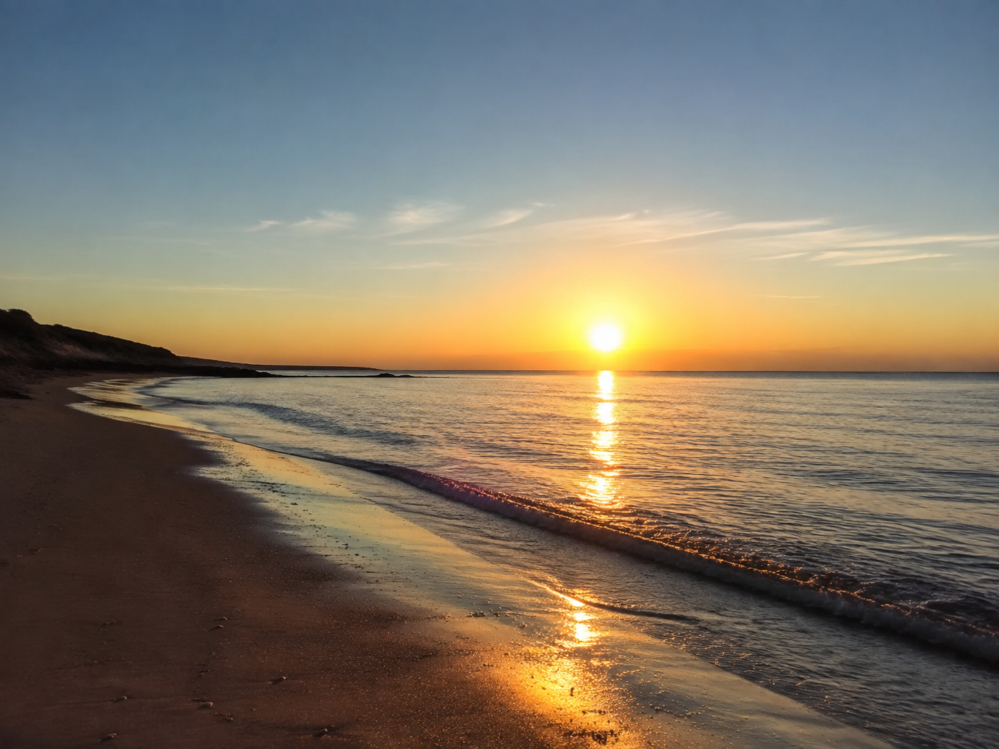 A low golden sun reflected across the sea