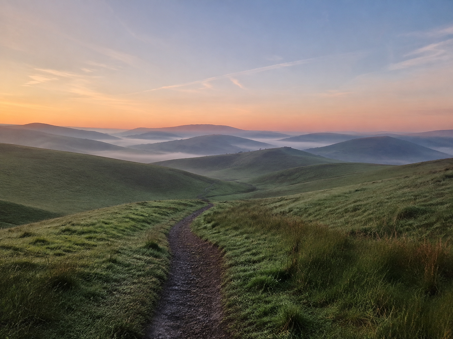 Soft morning light above misty hills